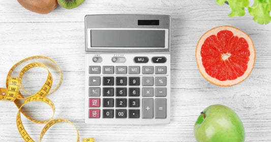 Counting calories with fruits, tape measure, and calculator.