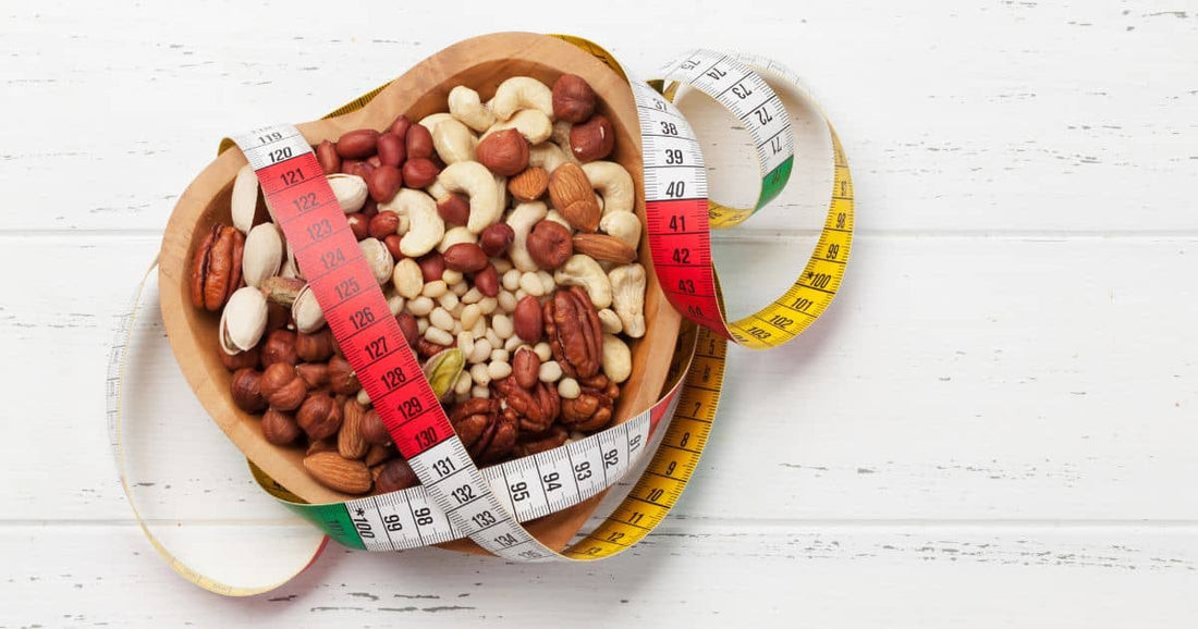 Bowl of mixed nuts for weight loss with tape measure.
